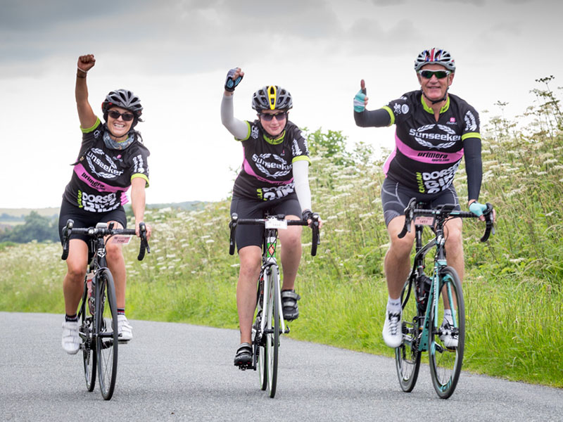three charity cyclists side by side